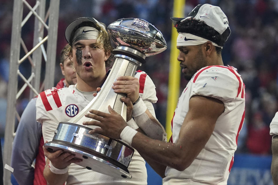 Mississippi celebrates with the Championship trophy after the Peach Bowl NCAA college football game between Penn State and Mississippi, Saturday, Dec. 30, 2023, in Atlanta. Mississippi won 38-25. (AP Photo/Brynn Anderson)