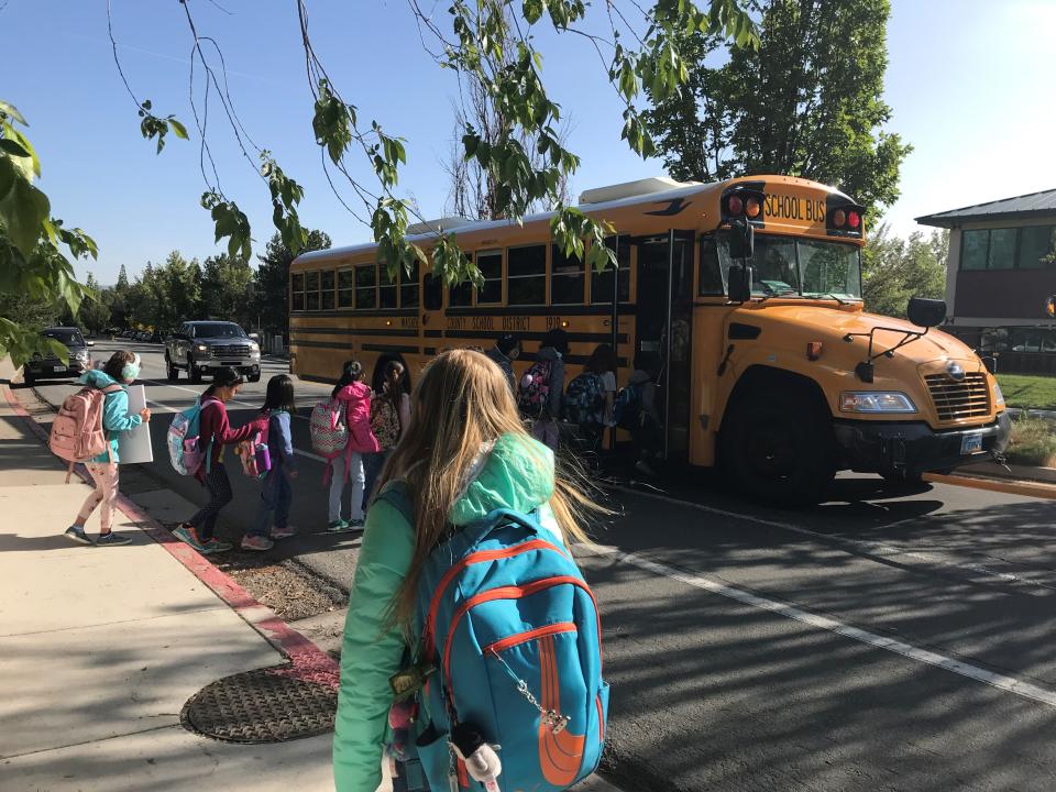 Washoe County School District elementary school students board the bus outside of the Aspen Ridge Apartments in south Reno.