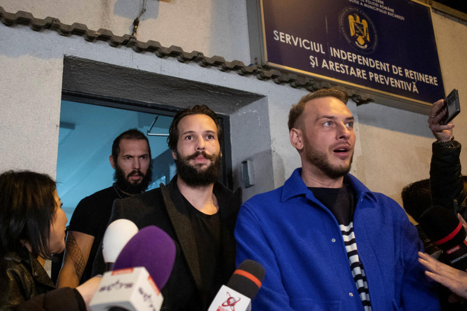 Andrew Tate and Tristan Tate, escorted by their lawyer, move to house arrest after being held in police custody, in Bucharest, Romania, March 31, 2023. Inquam Photos/Ilona Andrei via REUTERS ATTENTION EDITORS - THIS IMAGE WAS PROVIDED BY A THIRD PARTY. ROMANIA OUT. NO COMMERCIAL OR EDITORIAL SALES IN ROMANIA 