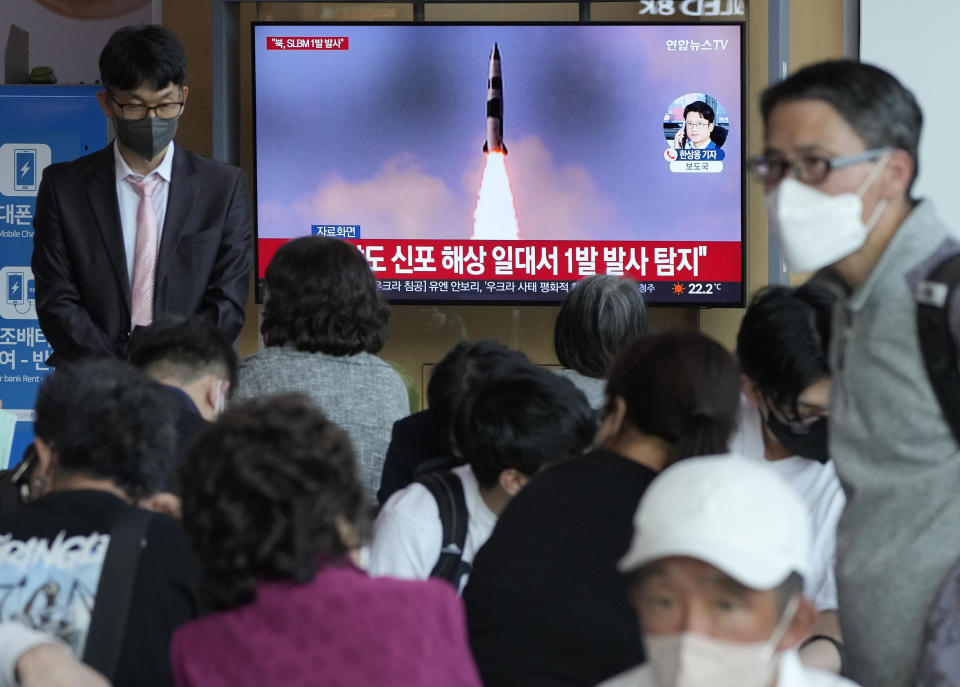 People watch a TV showing a file image of North Korea's missile launch during a news program at the Seoul Railway Station in Seoul, South Korea, Saturday, May 7, 2022. North Korea fired a suspected ballistic missile designed to be launched from a submarine on Saturday, South Korea's military said, apparently continuing a provocative streak in weapons demonstrations that may culminate with a nuclear test in the coming weeks or months. (AP Photo/Ahn Young-joon)