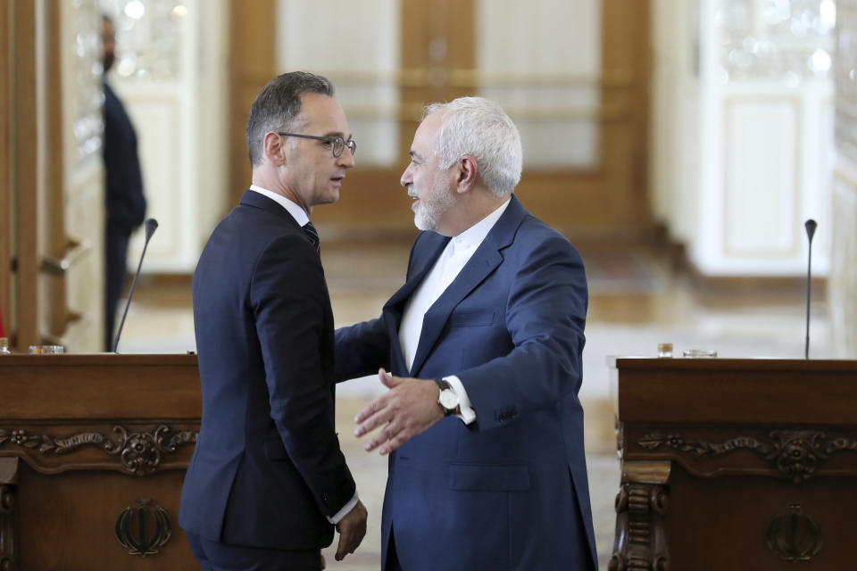 Iranian Foreign Minister Mohammad Javad Zarif, right, gestures to his German counterpart Heiko Maas at the end of their joint press conference in Tehran, Iran, Monday, June 10, 2019. Zarif warned the U.S. on Monday that it "cannot expect to stay safe" after launching what he described as an economic war against Tehran, taking a hard-line stance amid a visit by Germany's top diplomat seeking to defuse tensions. (AP Photo/Ebrahim Noroozi)