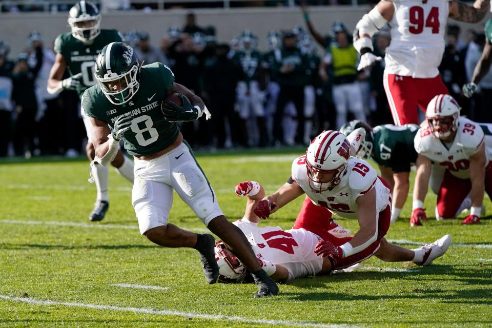 Michigan State running back Jalen Berger (8) breaks away from Wisconsin safety Titus Toler (41) for a 12-yard touchdown run during the first half on Saturday, Oct. 15, 2022, in East Lansing, Michigan. Berger began his college career at Wisconsin.