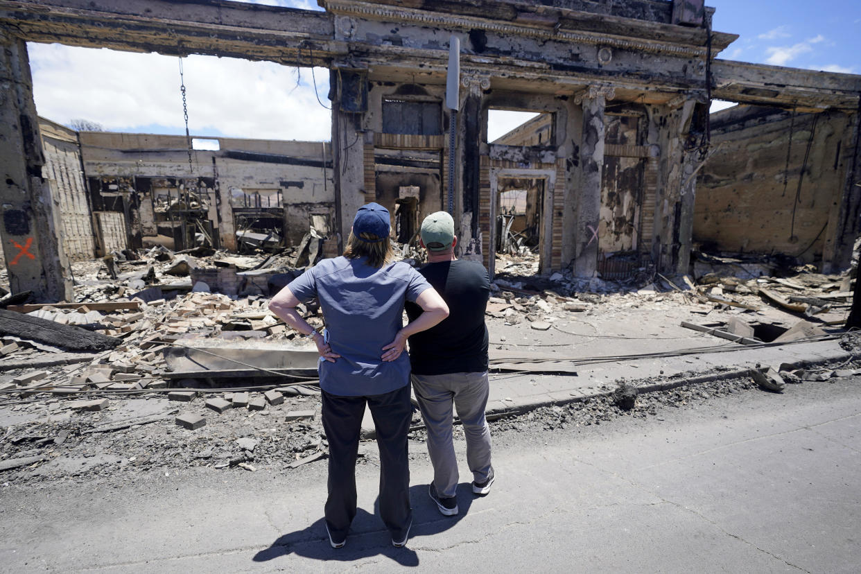 Governor of Hawaii Josh Green, right, and FEMA Administrator Deanne Criswell look at a destroyed building along Front Street during a tour of wildfire damage on Saturday, Aug. 12, 2023, in Lahaina, Hawaii. (AP Photo/Rick Bowmer)