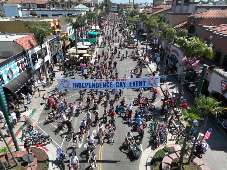 Huntington Beach, CA - June 29: Hundreds of patriotic bicyclists cruise down Main Street during the 5th Annual Huntington Beach Locals 4th of July Bicycle Cruise in advance of the annual Independence Day parade and fireworks in Huntington Beach. Kids, families, pets and neighbors were led by the Huntington Beach Veterans in the parade which began at Yorktown Ave. and Main Street, ending at Main Street and Walnut Ave. in Huntington Beach Saturday, June 29, 2024. (Allen J. Schaben / Los Angeles Times)