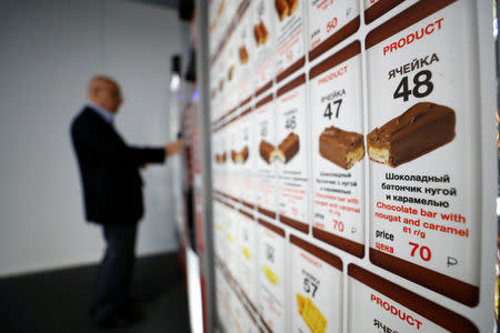 A man stands next to unbranded vending machine at Spartk Stadium in Moscow, Russia June 19, 2018. REUTERS/Kai Pfaffenbach