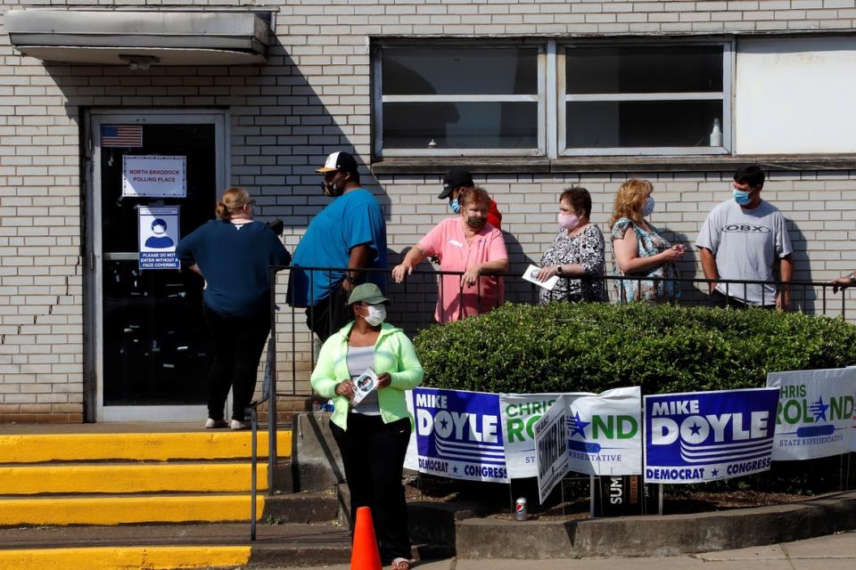 Voters wait in line to vote in the Pennsylvania primary outside the North Braddock Municipal Building on June 2, 2020.  