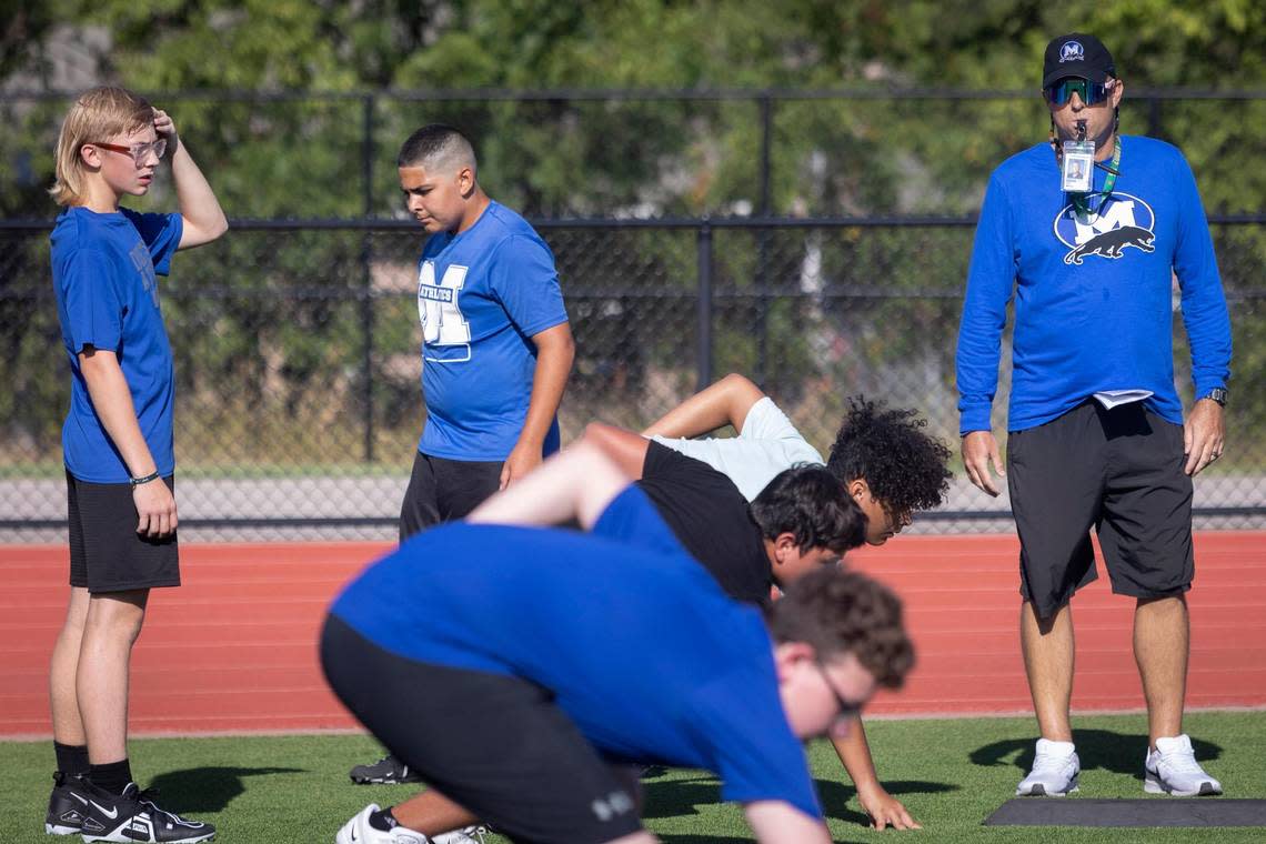 Freshman football coach Clif White runs drills with players during freshman football camp at Midlothian High School on Thursday, July 28, 2022. “Cancer might be overtaking my body, but it’s not overtaking my mind,” said White who is in between rounds of chemotherapy.