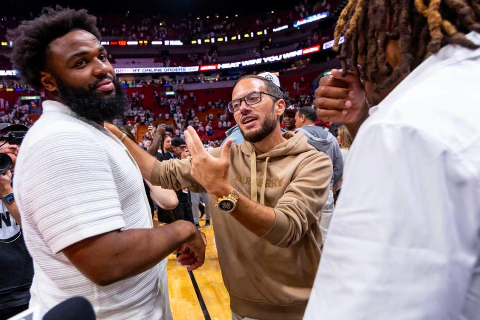 Miami Dolphins Head Coach Mike McDaniel, center, reacts with players Christian Wilkins, left, and Jalen Ramsey, right, react from courtside seats during the second half of Game 3 of the NBA Eastern Conference Finals series between the Miami Heat and Boston Celtics at Kaseya Center in Miami, Florida, on May 21, 2023.