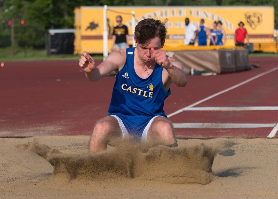 Castle’s Cadin Kramer lands in the long jump pit during the SIAC track and field meet at Central High School Tuesday eying, May 11, 2022. 