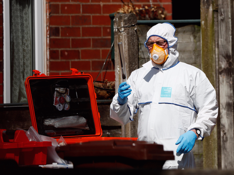 Police investigators work at residential property in south Manchester, Britain May 23, 2017.