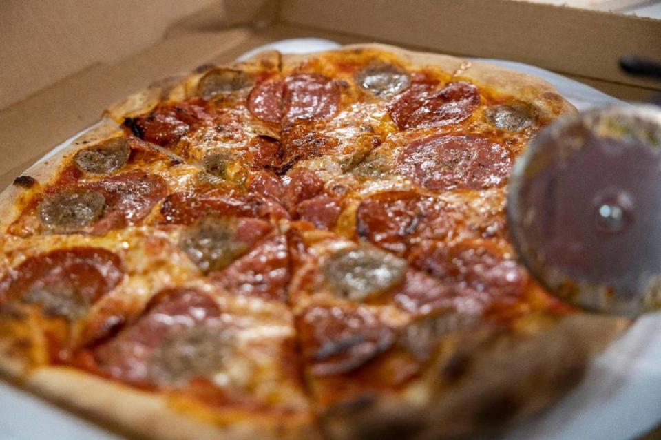 A freshly baked sausage pepperoni pizza, cut into eight slices at the Pizza Tascio in North Kansas City.
