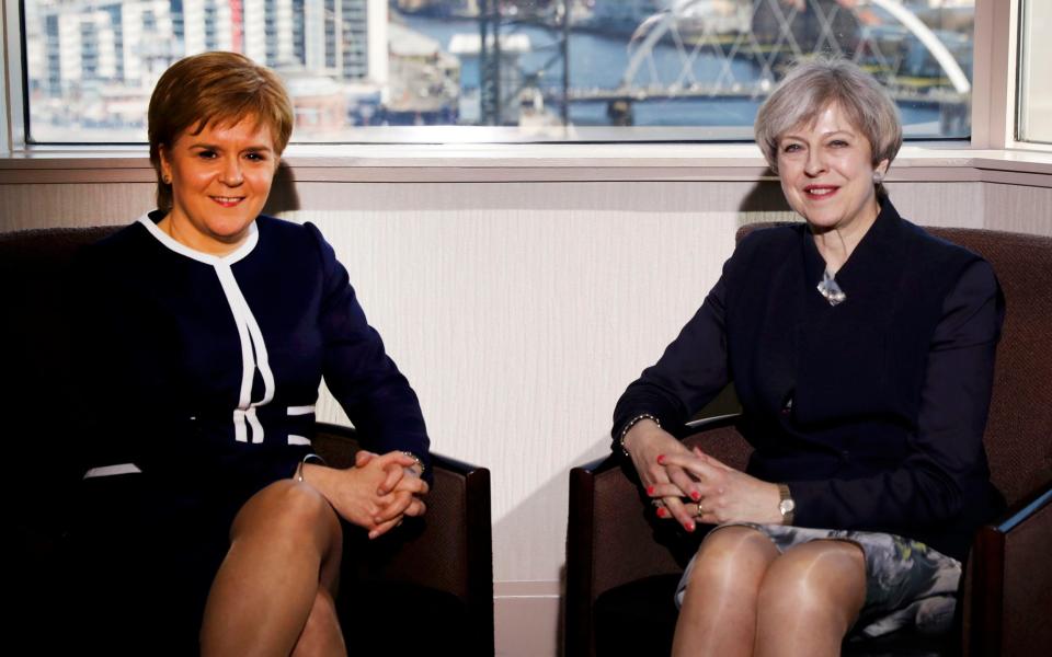 Britain's Prime Minister Theresa May and Scotland's First Minister Nicola Sturgeon meet in a hotel in Glasgow, Scotland - Credit: RUSSELL CHEYNE/REUTERS