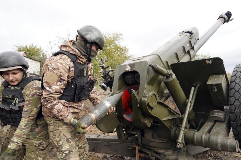 Ukrainian soldiers fire, on the front line in the Kharkiv region, Ukraine, Wednesday, Oct. 5, 2022. (AP Photo/Andrii Marienko)