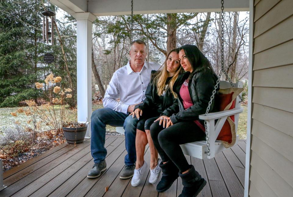 Janine Passaretti-Molloy, right, mother of crash victim Olivia Passaretti, with daughter Victoria and husband Dennis Molloy at their home in East Greenwich in March.