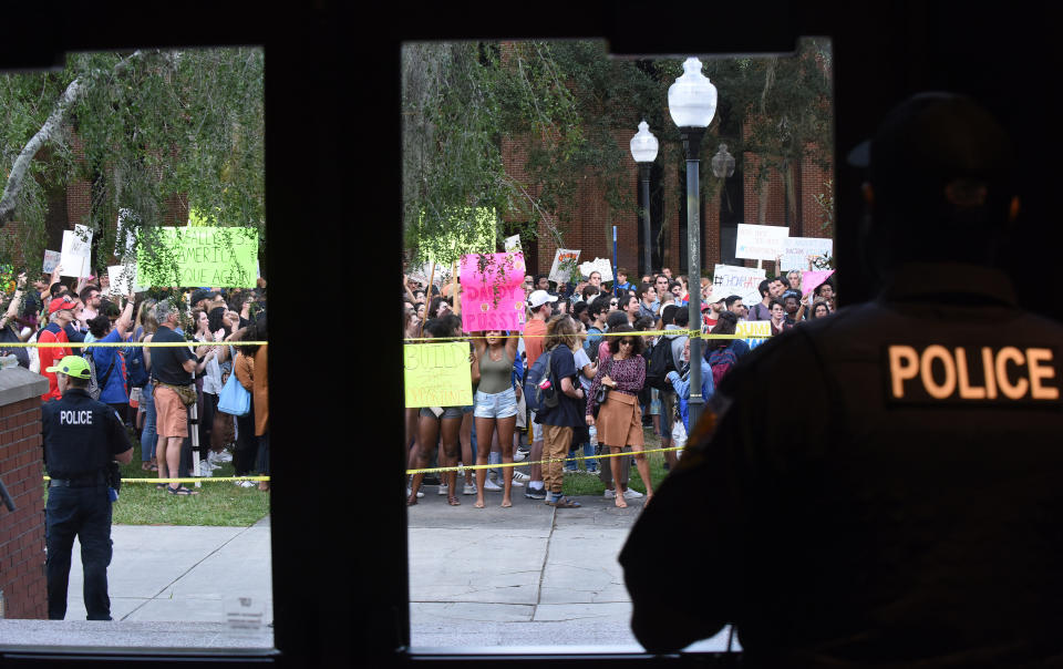 Police watch protesters before a speech by Trump Jr. and Guilfoyle, in what was billed as a keynote presentation. (Photo: SOPA Images via Getty Images)