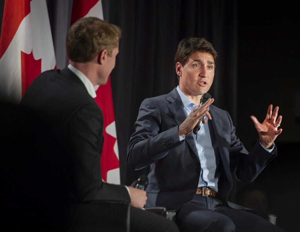 Prime Minister Justin Trudeau, Liberal Party, of Canada Leader, speaks to supporters as Marc Miller, MP of Ville-Marie-Le Sud-Ouest-Ile-des-Soeurs, looks on during an armchair discussion at an open Liberal Party fundraising event in Montreal, Quebec, Monday, June 17, 2019. (Peter McCabe/The Canadian Press via AP)