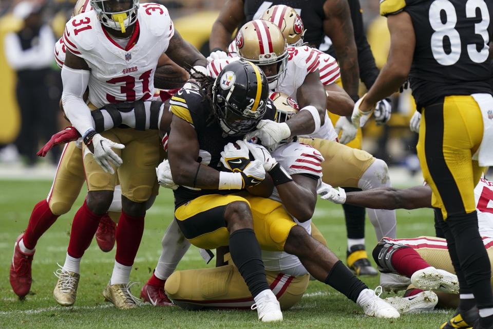 Pittsburgh Steelers running back Najee Harris (22) is tackled by San Francisco 49ers defenders during the first half of an NFL football game Sunday, Sept. 10, 2023, in Pittsburgh. (AP Photo/Matt Freed)