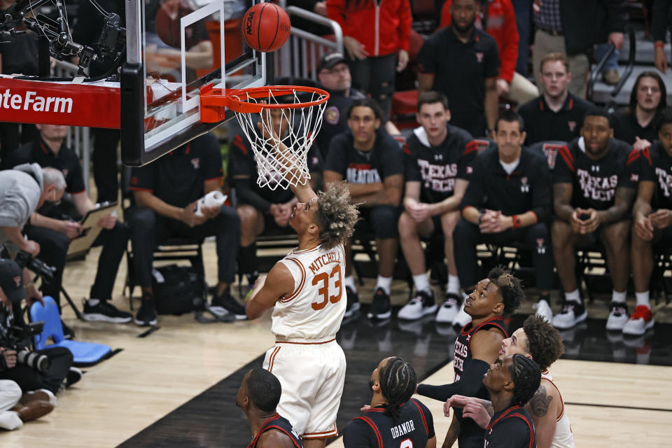 Texas' Tre Mitchell (33) lays up the ball during the first half of an NCAA college basketball game against Texas Tech, Tuesday, Feb. 1, 2022, in Lubbock, Texas. (AP Photo/Brad Tollefson)