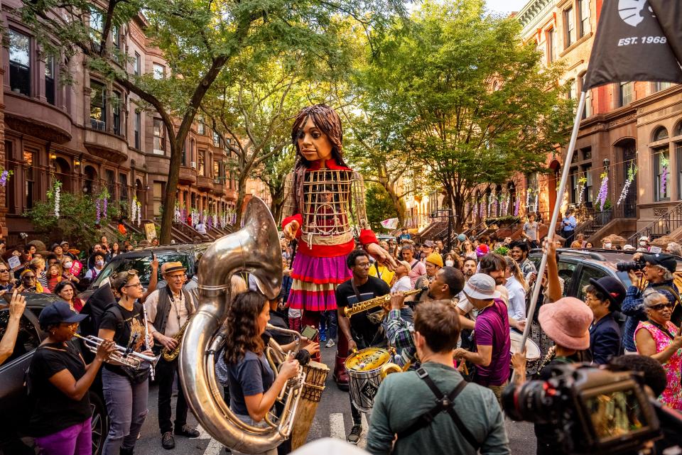The Brooklyn community welcomes Little Amal during her visit through the five boroughs of New York City in 2022. The 12-foot puppet will walk across the Roebling Bridge from Covington to Downtown Sept. 22 as part of her current journey across the United States.