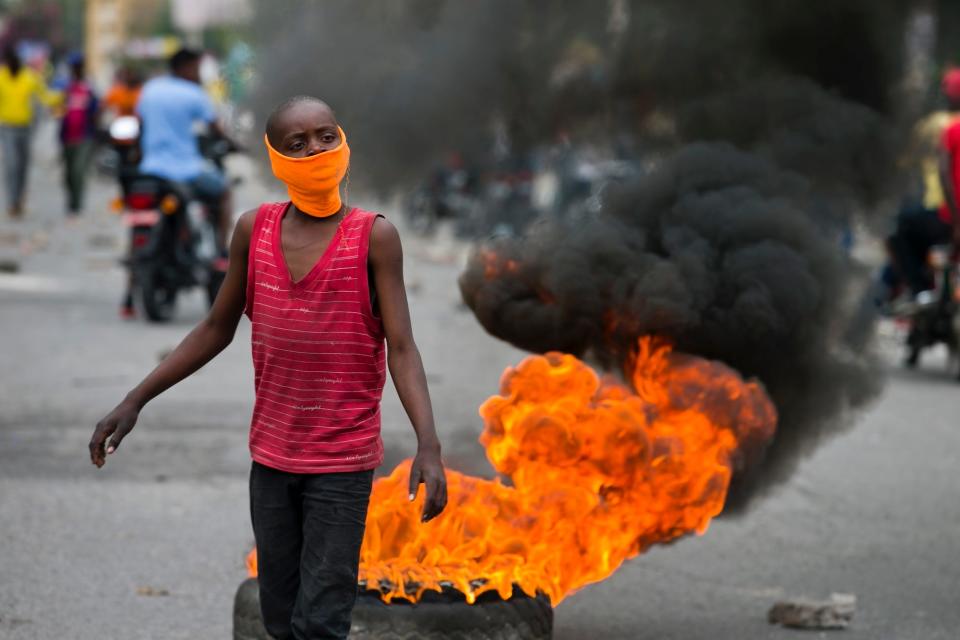 A boy chants anti-army slogans as off-duty police officers protest over pay and working conditions, in Port-au-Prince, Haiti, Monday, Feb. 24, 2020.