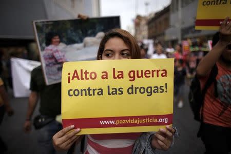 A woman holds a placard that reads 'Stop the drug war' during a march with human rights activists and families of victims of violence, in Monterrey, Mexico April 13, 2016. REUTERS/Daniel Becerril