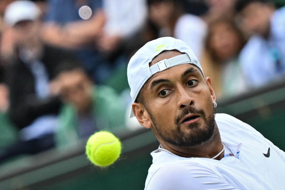 Australia's Nick Kyrgios eyes the ball as he returns it to Serbia's Filip Krajinovic during their men's singles tennis match on the fourth day of the 2022 Wimbledon Championships at The All England Tennis Club in Wimbledon, southwest London, on June 30, 2022. - RESTRICTED TO EDITORIAL USE (Photo by Glyn KIRK / AFP) / RESTRICTED TO EDITORIAL USE (Photo by GLYN KIRK/AFP via Getty Images)