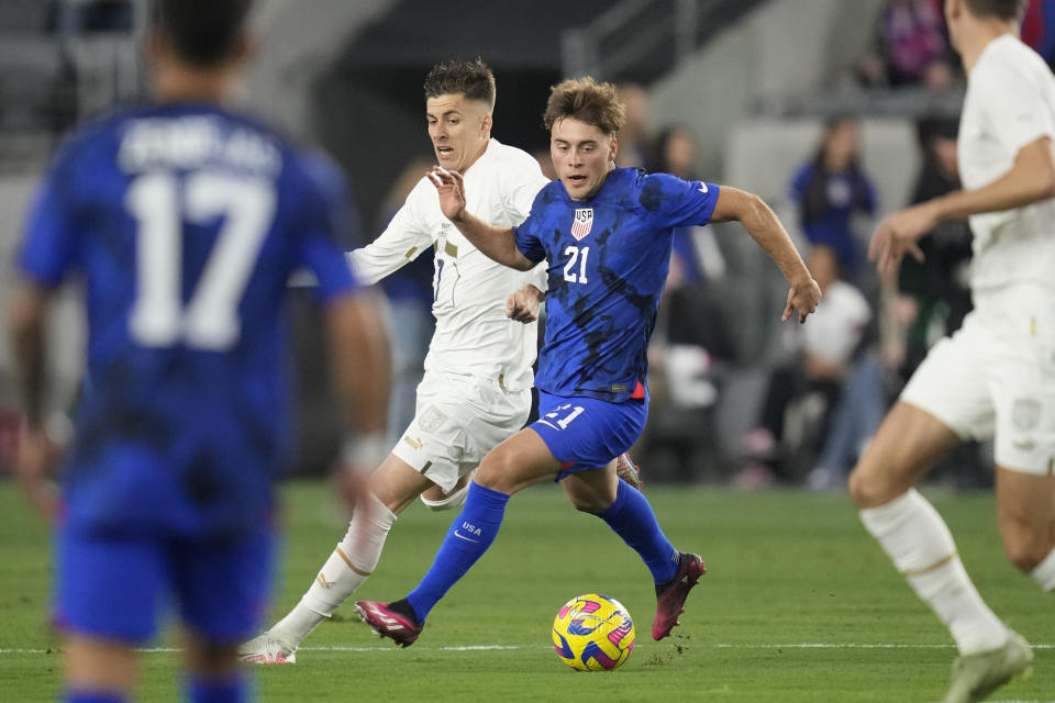 Serbia midfielder Luka Ilić (7) defends against United States midfielder Aidan Morris (21) during the first half of an international friendly soccer match in Los Angeles, Wednesday, Jan. 25, 2023. (AP Photo/Ashley Landis)