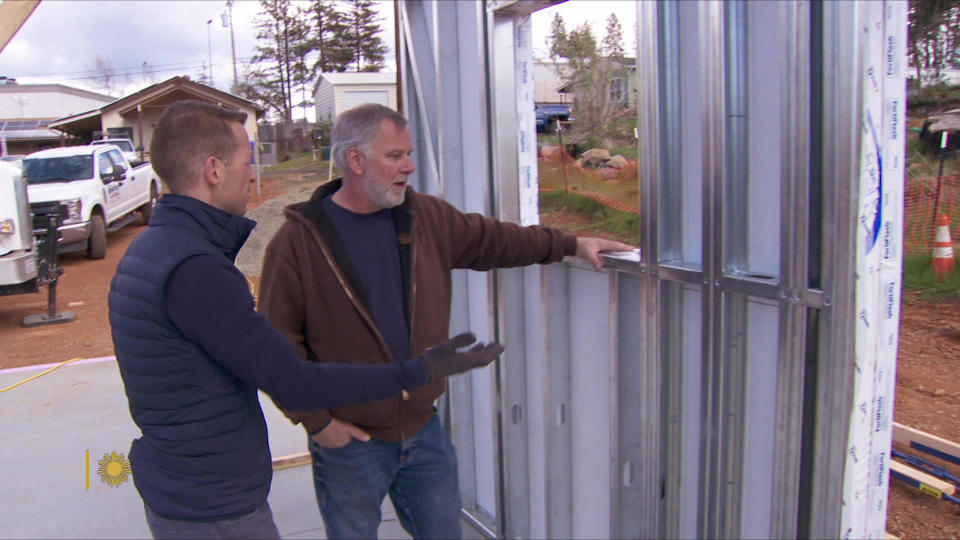 Vern Sneed of Design Horizons shows correspondent Ben Tracy the noncombustible materials used in a Q Cabin.  / Credit: CBS News