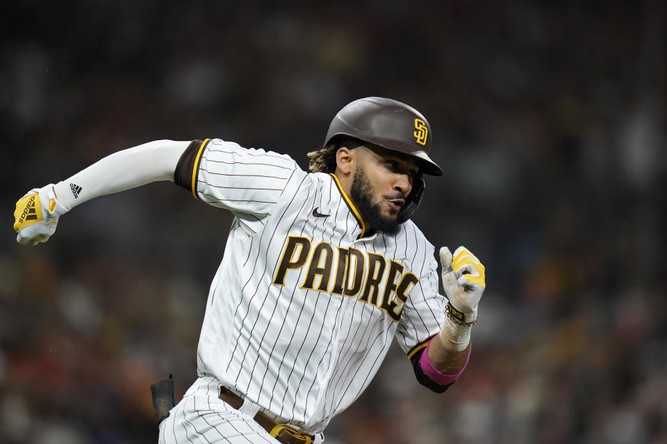 San Diego Padres' Fernando Tatis Jr. runs to first after hitting a single during the sixth inning of a baseball game against the San Francisco Giants, Tuesday, Sept. 21, 2021, in San Diego. (AP Photo/Gregory Bull)