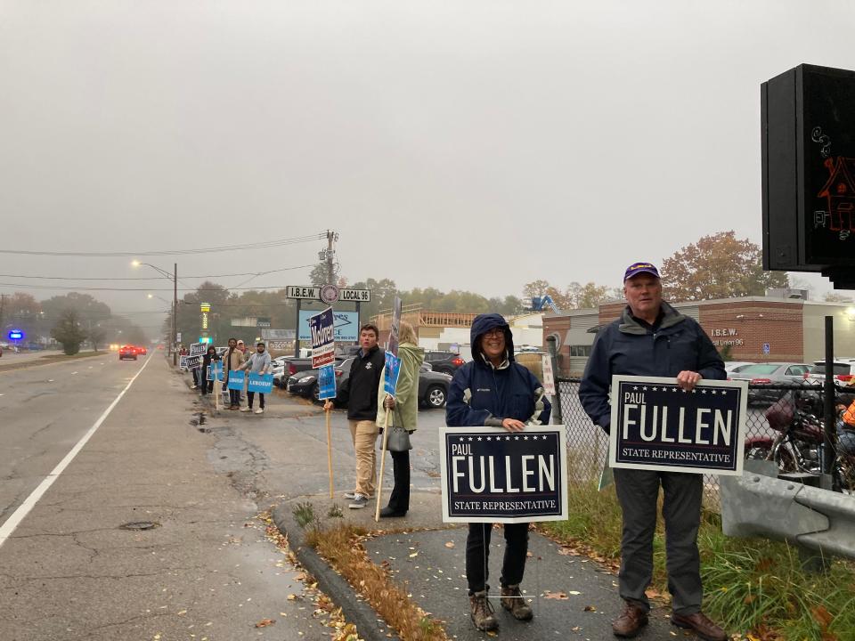 Sign holders turned out in the drizzle Monday to support candidates for the 17th Worcester District, incumbent Democrat Rep. David LeBoeuf and challenger Republican Paul Fullen.