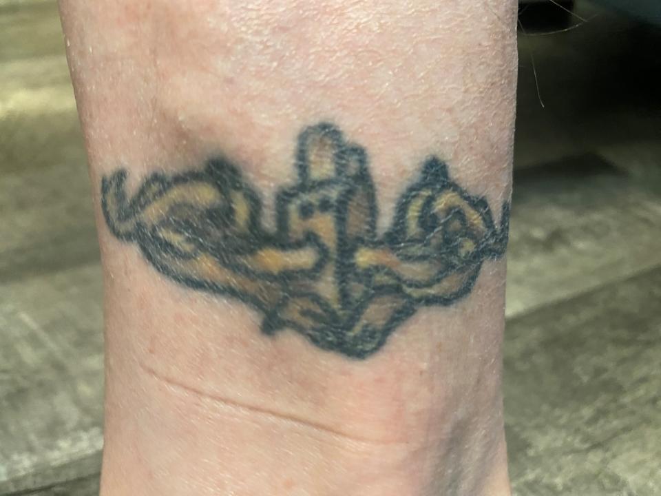 Bret Pasiuk has the Submarine Warfare insignia for qualifying in submarines in the US Navy tattooed on his ankle. He earned his insignia in 1991 and had it tattooed in 2013.