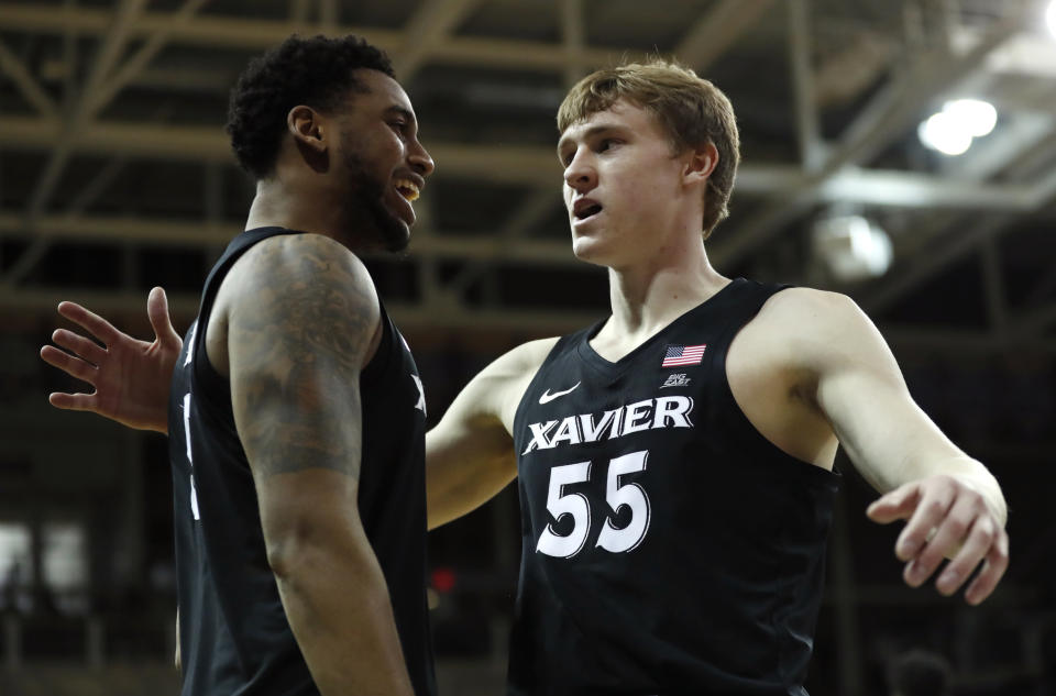 J.P. celebrates with Trevon Bluiett after a victory over Northern Iowa. (AP Photo/Charlie Neibergall)