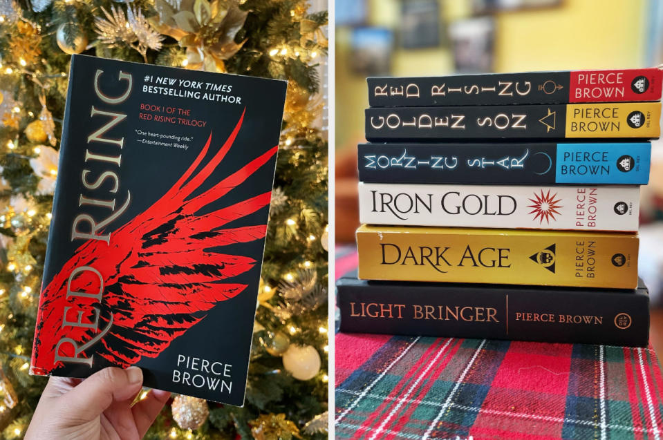 The author is showing off the "Red Rising" series by Pierce Brown