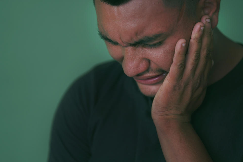 Jesús closes his eyes as he tells the story of his mother, Manuela, who was arrested in 2008 on suspicion of breaching El Salvador’s abortion law after she suffered an obstetric emergency, in San Salvador, El Salvador, on Wednesday, May 18, 2022. He and his younger brother were left orphaned after she died in 2010 while serving a 30-year sentence. He now retells this painful story in hopes that other children won’t have to face the same suffering. (AP Photo/Jessie Wardarski)