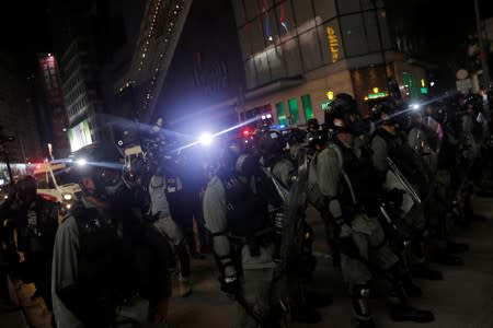 Riot police chase away anti-government protesters near Causeway Bay metro station, after leader Carrie Lam announced emergency laws that would include banning face masks at protests, in Hong Kong