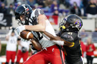 Cincinnati's Alec Pierce (12) catches the ball over East Carolina's Ja'Quan McMillian (21) during the first half of an NCAA college football game in Raleigh, N.C., Friday, Nov. 26, 2021. (AP Photo/Karl B DeBlaker)