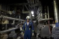 A worker poses for a photo at Cenovus' Sunrise oil facility northeast of Fort McMurray on Thursday, Aug. 31, 2023. (AP Photo/Victor R. Caivano)