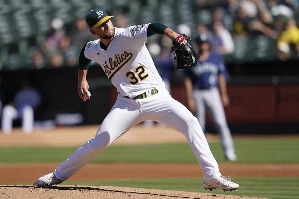 Oakland Athletics' James Kaprielian pitches against the Seattle Mariners during the first inning of a baseball game in Oakland, Calif., Saturday, Aug. 20, 2022. (AP Photo/Jeff Chiu)