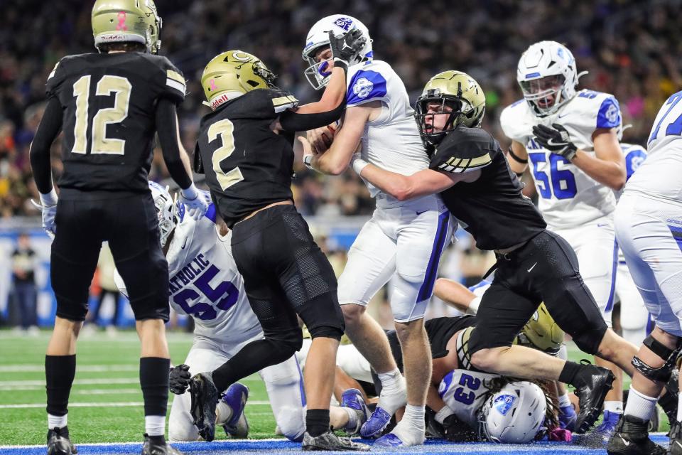 Grand Rapids Catholic Central quarterback Connor Wolf runs for a touchdown against Corunna during the first half of the Division 5 football state final on Sunday, Nov. 26, 2023, at Ford Field.