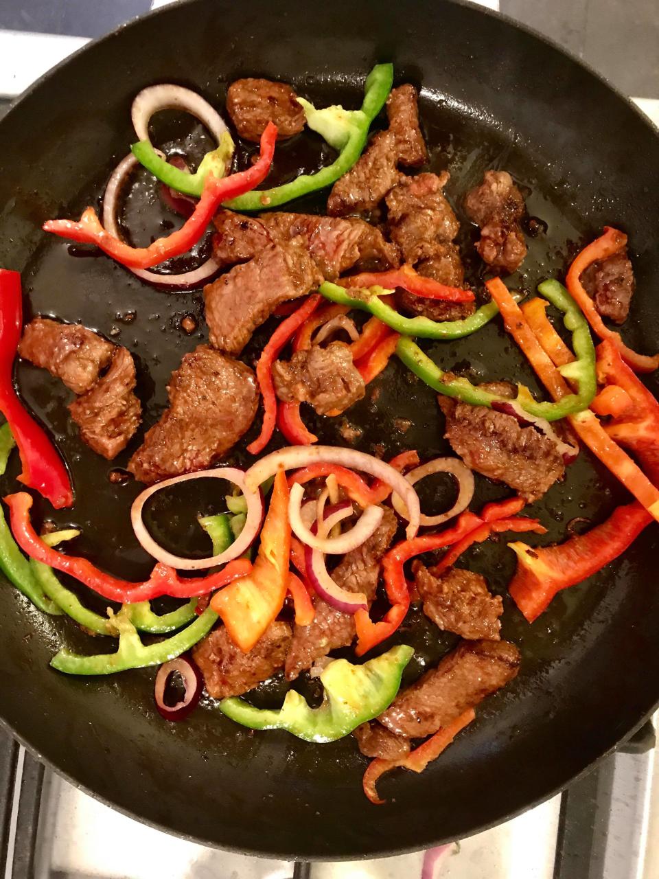 Chef tip: constantly turn the beef and veggies to release the aromas of the marinade. Photo: Carly Williams/Yahoo Lifestyle