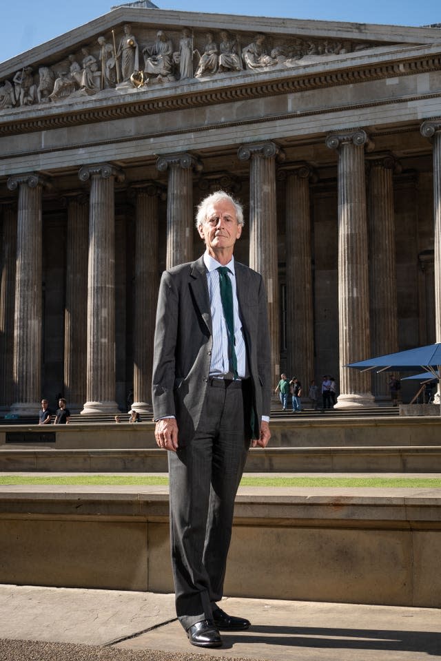 Sir Mark Jones standing in profile outside the entrance to the British Museum in London