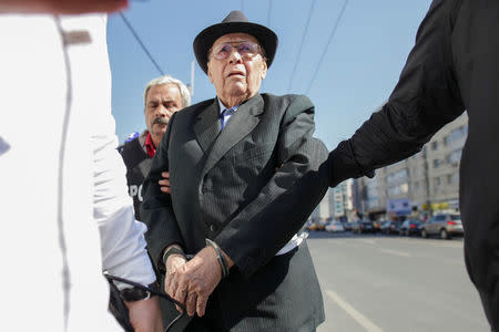 Ioan Ficior, 89, a Romanian communist-era labour prison commander is escorted by police at the end of his trial in Bucharest, Romania, March 29, 2017. Inquam Photos/Liviu Florin Albei via REUTERS