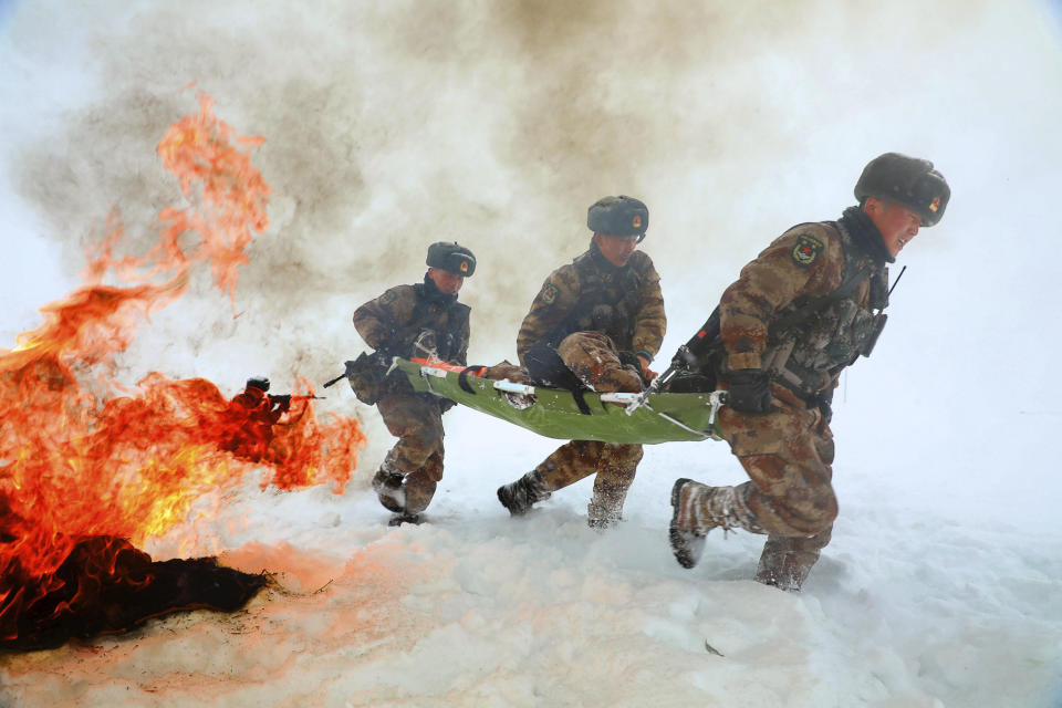 Soldiers go through field exercises in the snow near the Kunjerab Pass bordering Pakistan in Taxkorgan in northwest China's Xinjiang Uyghur Autonomous Region on Jan. 6, 2021. China appointed on Friday, Aug. 6, 2021 a new military commander in restive Xinjiang where authorities have locked up more than a million members of Muslim minorities in what they call a bid to curb terrorism and radicalism. (Chinatopix via AP) CHINA OUT