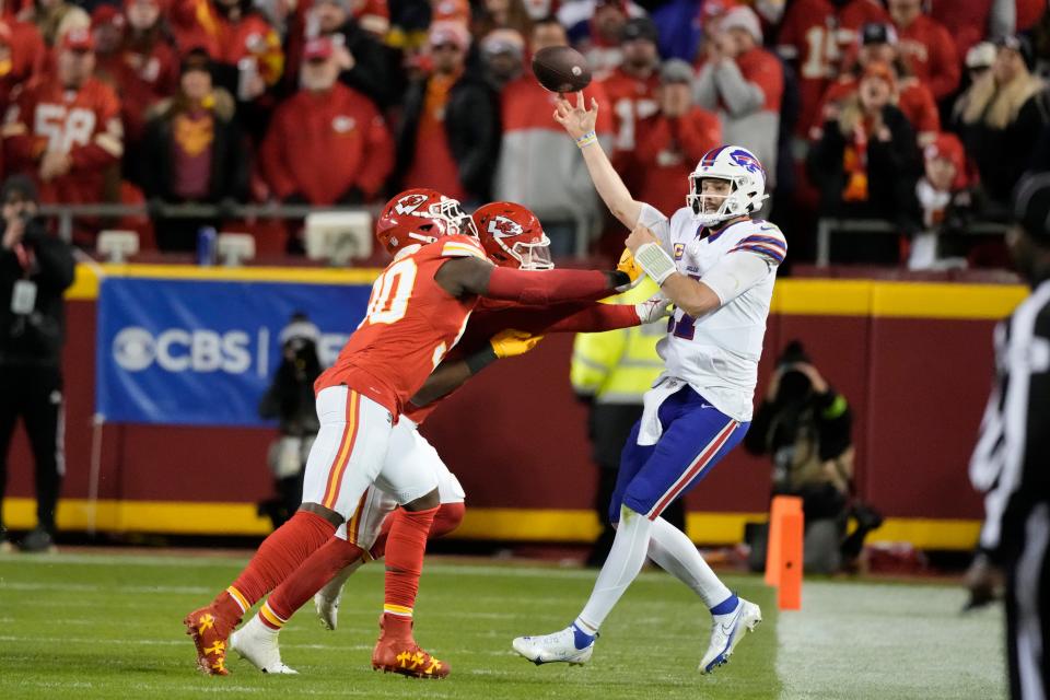 Buffalo Bills quarterback Josh Allen, right, stays in bounds as he throws under pressure during the second half of an NFL football game against the Kansas City Chiefs Sunday, Dec. 10, 2023, in Kansas City, Mo. (AP Photo/Charlie Riedel)