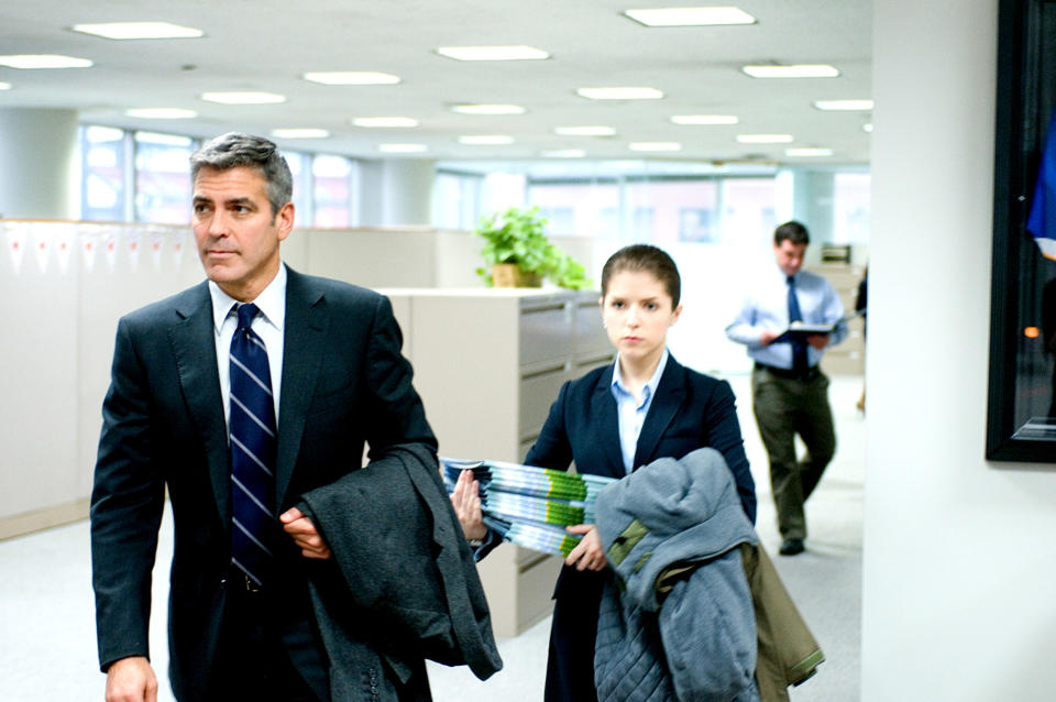 George Clooney and Anna Kendrick walk through an office