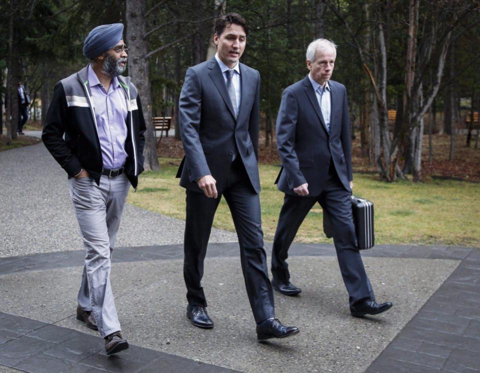 Prime Minister Justin Trudeau, centre, arrives with Minister of National Defence Harjit Sajjan, left, and Minister of Foreign Affairs Stephane Dion, for meetings at a Liberal Party cabinet retreat in Kananaskis, Alta., Monday, April 25, 2016.THE CANADIAN PRESS/Jeff McIntosh