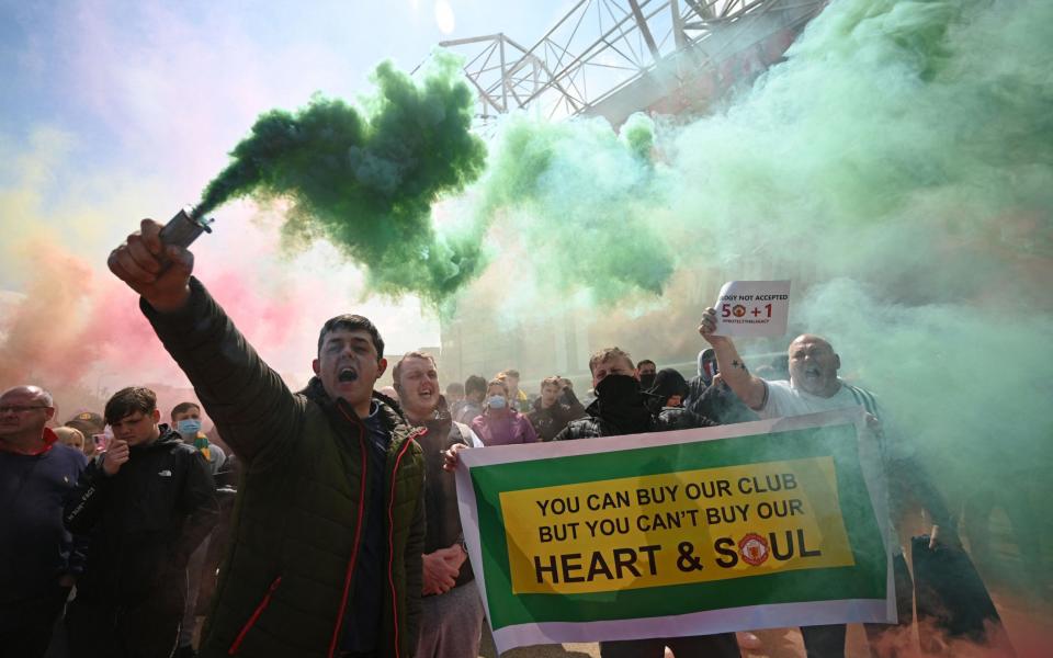 Supporters protest against Manchester United's owners, outside English Premier League club Manchester United's Old Trafford stadium in Manchester, north west England on May 2, 2021,