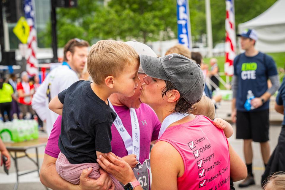 Samantha Salway giving her son, Gavin, a kiss at the Cleveland Marathon on Saturday, May 18, 2024.