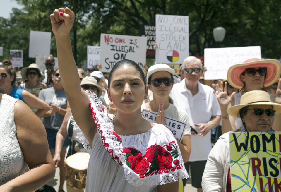 <p>Maria Montelongo raises her fist at the Families Belong Together rally at the Capitol in Austin, Texas, on Saturday, June 30, 2018. Thousands gathered at the Capitol to protest family separations on the border. (Jay Janner/Austin American-Statesman via AP) </p>