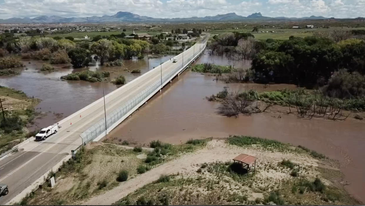 People drive over a bridge in Duncan, Ariz., following a flooding. (Stan Ellis)